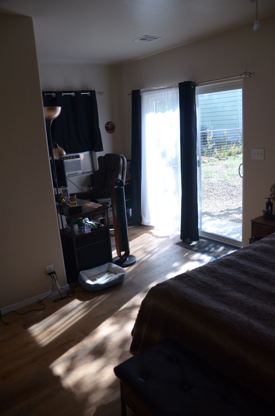 Primary bedroom with sliding door to the backyard